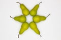 Pears laid out in a circle. Star made from pears on white background. Ripe pears laid out in the shape of an eight-pointed Star