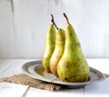 Pears on a plate, napkin on a white wooden background Royalty Free Stock Photo