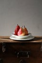Pears. Three pears on a porcelain plate on wooden background. Rustic style. Royalty Free Stock Photo