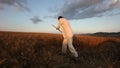 Peasant reaping wheat with a scythe