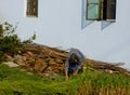 Peasant woman doing farm work in the farm garden