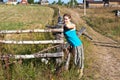 Peasant woman standing near village fence Royalty Free Stock Photo