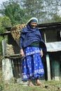 Peasant woman in traditional clothes of blue color with a basket