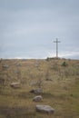 Peasant wooden cross on the mountain near the river bank, lake.