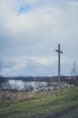 Peasant wooden cross on the mountain near the river bank, lake. Royalty Free Stock Photo