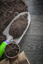 Peat glasses soil spade on wood board