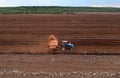 Peat Harvester Tractor on Collecting Extracting Peat. Mining and harvesting peatland. Area drained of the mire are used for peat