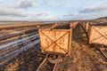 Peat mining area with old empty carts in the foreground Royalty Free Stock Photo