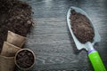 Peat pots soil spade on wood board