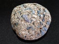 Pebble of Arkose sandstone on dark background Royalty Free Stock Photo