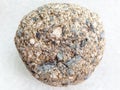 pebble of Arkose sandstone on white marble Royalty Free Stock Photo