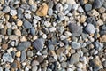 Pebble background texture with many pebbles of different sizes and shapes from Fistral beach Newquay