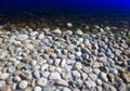 Pebble bank of pond dramatic background