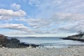 Pebble beach, ocean, drift wood, clouds, Maine, US Royalty Free Stock Photo