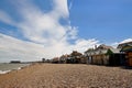 Pebble beach with a row of small huts Royalty Free Stock Photo