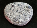 pebble of gray Arkose sandstone on dark background Royalty Free Stock Photo