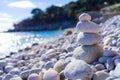 A pebble pyramid is built on the sunny seaside. Calmness, relaxation and peace