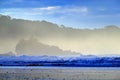 The pebble and sandy beach during sunrise, with dark blue waves and orange clouds, Costa Rica coast. Beautiful morning twilight se Royalty Free Stock Photo