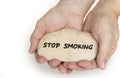 Pebble stone in hands. Concept for a stop smoking sign Royalty Free Stock Photo