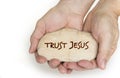 Pebble stone in hands. Concept for a trust jesus sign