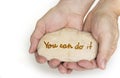 Pebble stone in hands. Concept for you can do it sign. Royalty Free Stock Photo