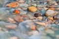 Pebble stones in the river water close up view