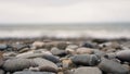 Pebble stones on the shore close up in the blurry light in the distance Royalty Free Stock Photo