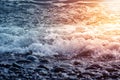 Pebble stones on the shore close up in the blurry sunset light in the distance background Royalty Free Stock Photo