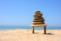 A pebble tower stands on the seashore on two thin stones. Royalty Free Stock Photo