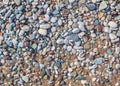 Pebbles background image. Rounded different size pebbles at beach side.