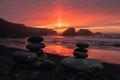 Pebbles balanced on top of each other on the beach during a sunset Royalty Free Stock Photo