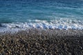 Pebbles on beach, blue sea and sky scenic view Royalty Free Stock Photo