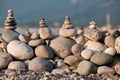 Pebbles on the beach collected in pyramids stones lie one on top of the other balance and harmony