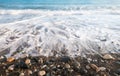 Pebbles in the beach with soft milky sea water