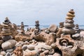 Pebbles heaped and balanced in a tower on top of mineral rocks in cityscape - Zen image of tranquility at Farol beach in Milfontes