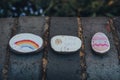 Pebbles painted with rainbow, Easter egg and stay safe message left on the street in London, UK