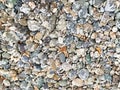 Pebbles rocks stones wet beach textured background