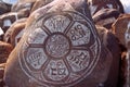 Pebbles from sacred Lake Manasarovar with hieroglyphs and main Buddhist mantra `Om Mani Padme Hum`. Royalty Free Stock Photo