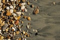 Pebbles on the seashore in close-up. A rocky beach. Rocks and sand in close-up. Royalty Free Stock Photo