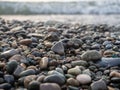 Pebbles on the seashore close-up. Rocky beach. Stones close-up with bokeh. Gray natural background. Autumn on the seashore