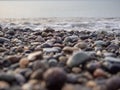 Pebbles on the seashore close-up. Rocky beach. Stones close-up with bokeh. Gray natural background. Autumn on the seashore