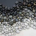 Pebbles in shades of black gray and white are arranged in a gradient Royalty Free Stock Photo