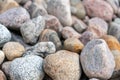 Pebbles on the shore. Round stones on the coast