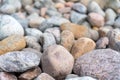 Pebbles on the shore. Round stones on the coast