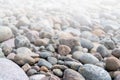 Pebbles on the shore. Round stones on the coast