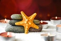 Pebbles stack and starfish candles, Balance, Pyramid of stones for meditation, stack of zen stones, copy space, spa Royalty Free Stock Photo