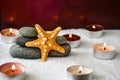 Pebbles stack and starfish candles, Balance, Pyramid of stones for meditation, stack of zen stones, copy space, spa