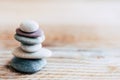 Pebbles stacked on a wooden background - Atmosphere of serenity