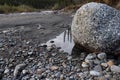 Stones on the beach and reflection in a puddle Royalty Free Stock Photo