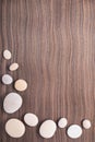 Pebbles on wooden ebony tree background